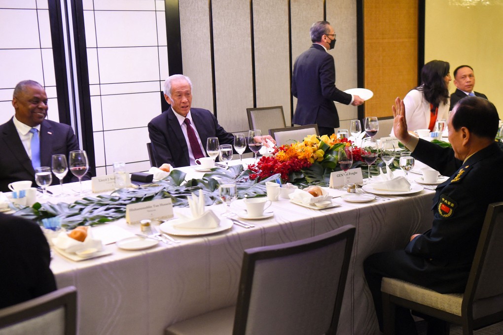 China’s Defense Minister Wei Fenghe, right, greets US Defense Secretary Lloyd Austin, left, as he sits across from Singapore’s Defense Minister Ng Eng Hen during the ministerial roundtable luncheon at the Shangri-La Dialogue summit in Singapore on Saturday. Photo: AFP/Getty Images/TNS