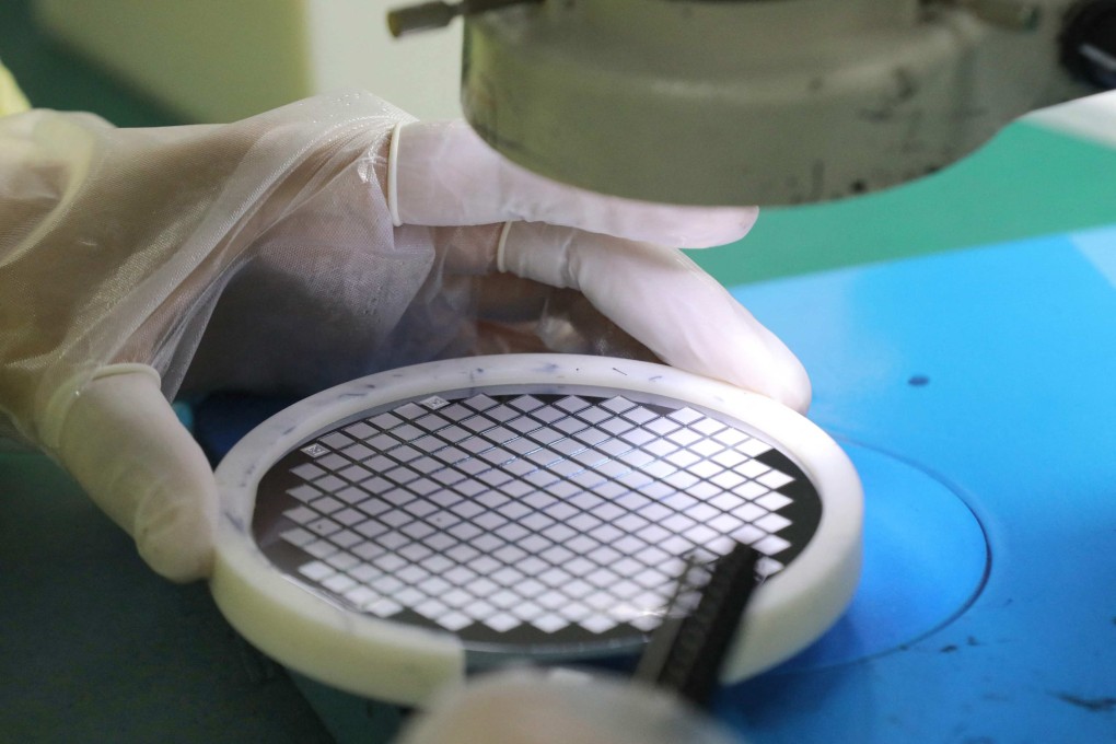 An employee makes a chip at a factory in Nantong in eastern China’s Jiangsu province. Photo: STR/AFP