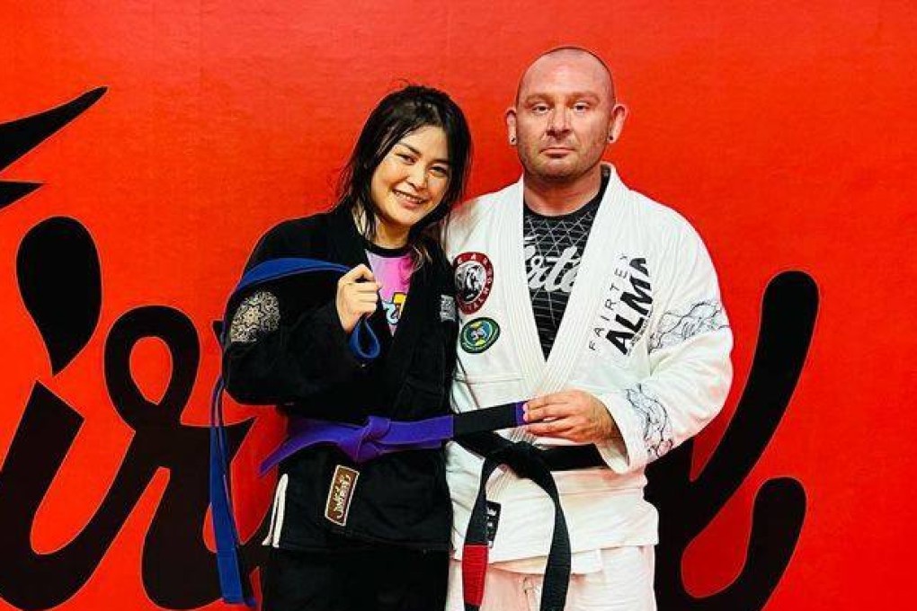 Stamp Fairtex receives her Brazilian jiu jitsu purple belt from professor Jason Burnworth. Photo: Instagram/@stamp_fairtex