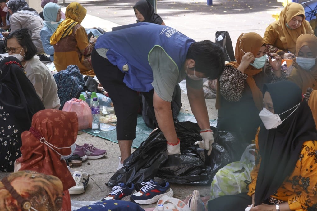 A cleaner fills a rubbish bag at a park in Hong Kong on May 29. Contract workers don’t just have to put up with long hours and low pay, many also suffer poor working conditions. Photo: K. Y. Cheng