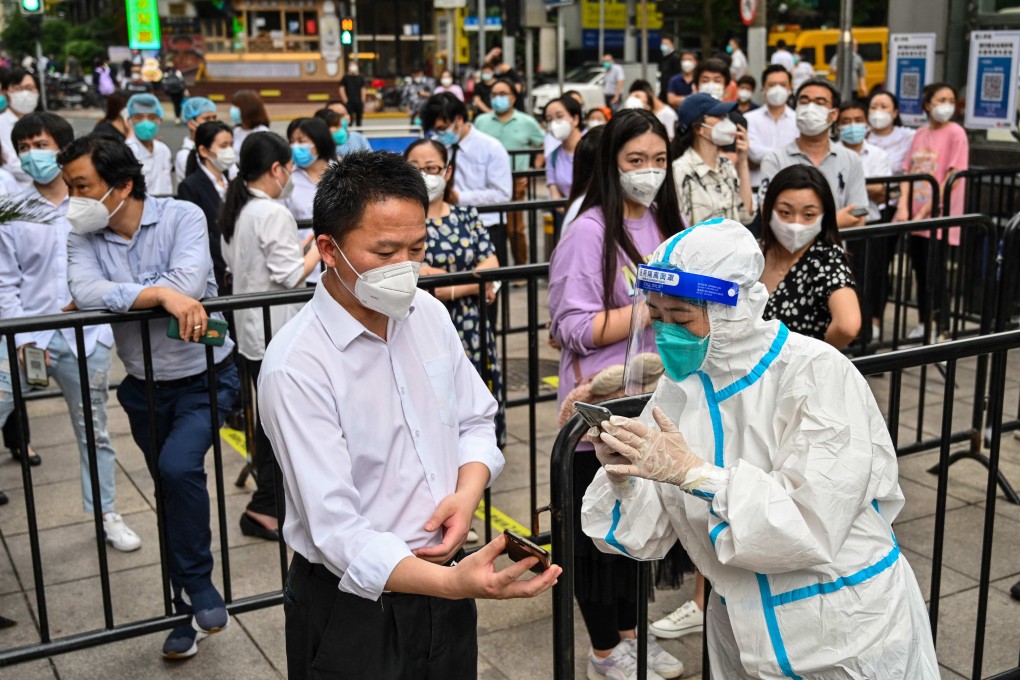 A medical worker scans a QR health code before taking a swab sample in Shanghai’s Huangpu district on June 1. Photo: AFP