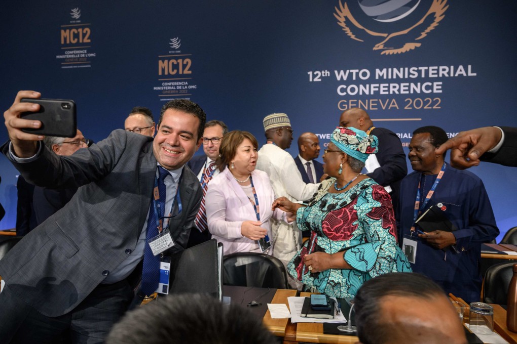 Delegates react with World Trade Organization Director General Ngozi Okonjo-Iweala (C) after the deals were reached. Photo: AFP