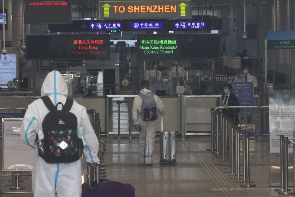 Cross-border travellers clad in PPE suits arrive at the Shenzhen Bay checkpoint on March 21. Photo: K.Y. Cheng