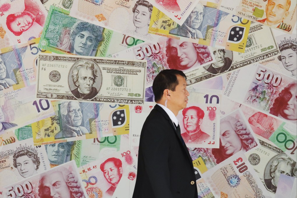 A man walks past a currency exchange store in Hong Kong’s Sheung Wan area. Photo: Felix Wong