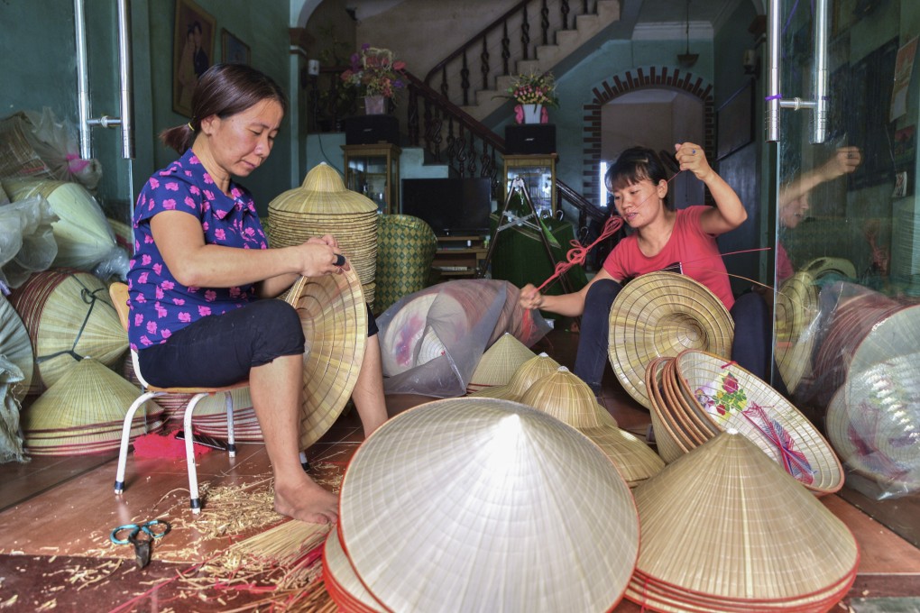 Artisans make conical hats in Chuong village, Hanoi, Vietnam. A dying trade because of cheaper factory-made hats, it could be revived by a new tourism strategy to promote the city’s craft villages. Photo: Ronan O’Connell