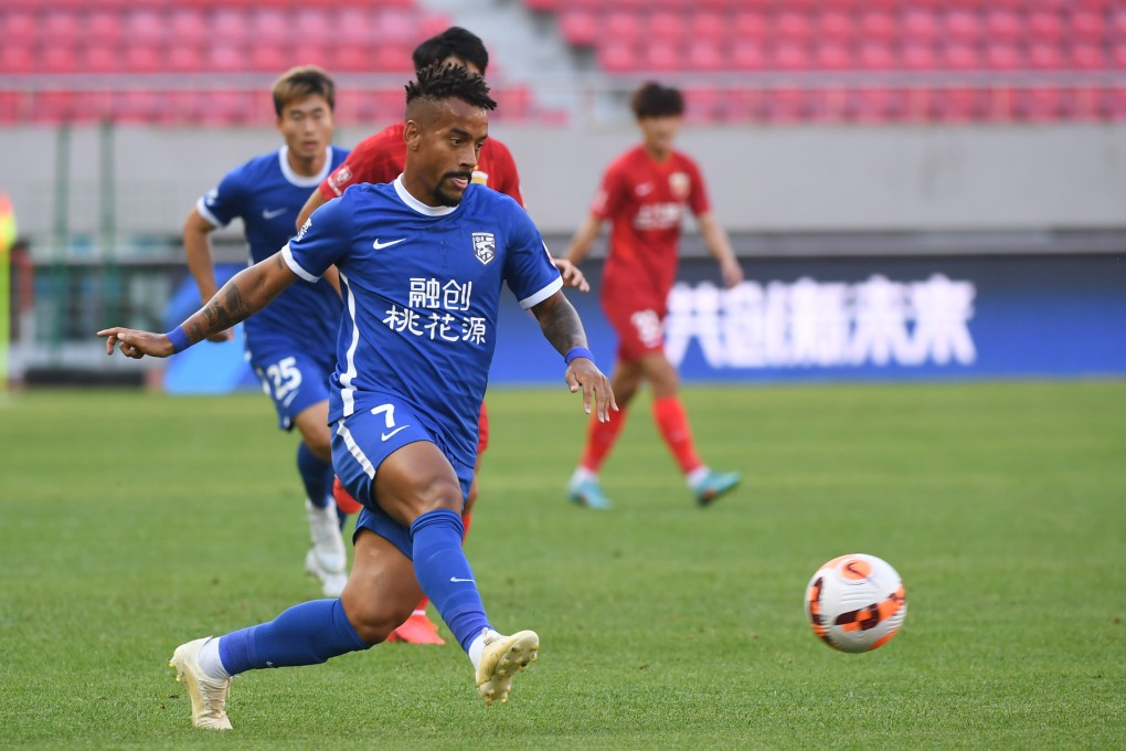 Ademilson of Wuhan Three Towns competes against Shanghai Port in Dalian. Photo: Xinhua