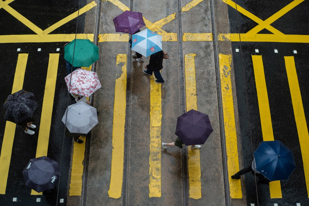 Pedestrians cross an intersection in Central, Hong Kong. Photo: EPA-EFE