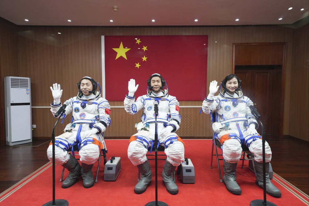 Chinese astronauts Cai Xuzhe, Chen Dong and Liu Yang wave before a send-off ceremony for the Shenzhou-14 crewed space mission, at the Jiuquan Satellite Launch Centre in northwestern China, on June 5. Photo: Xinhua