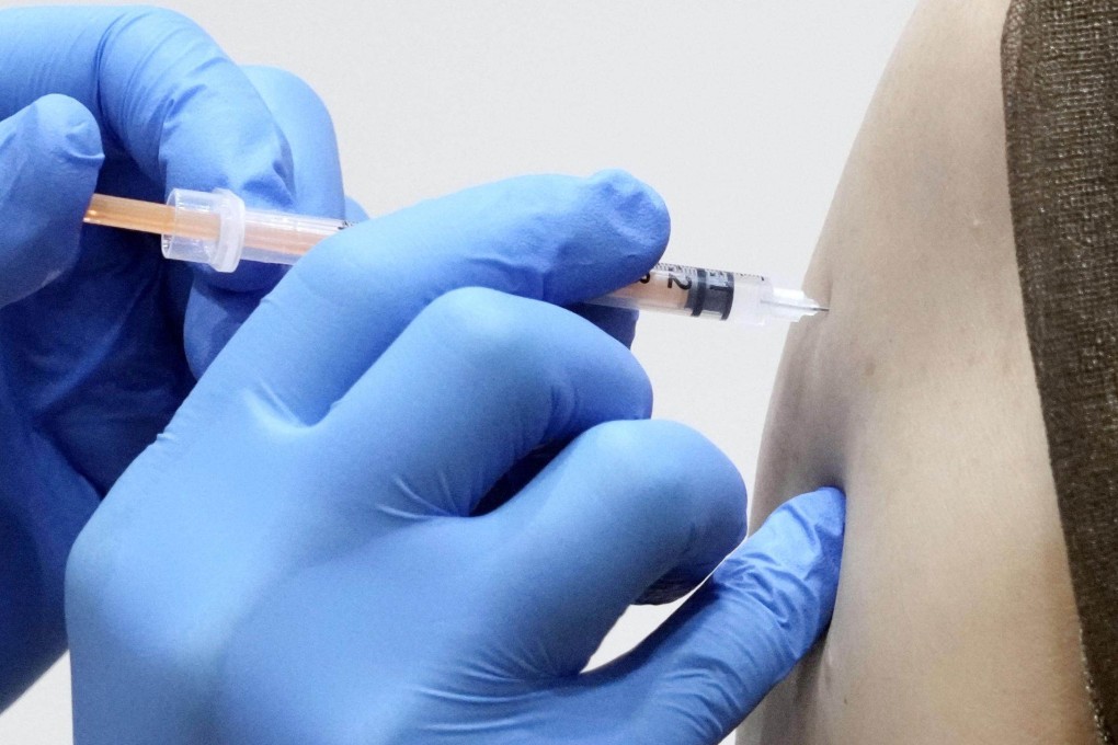 A health official gives a vaccination against Covid-19. Photo: Kyodo