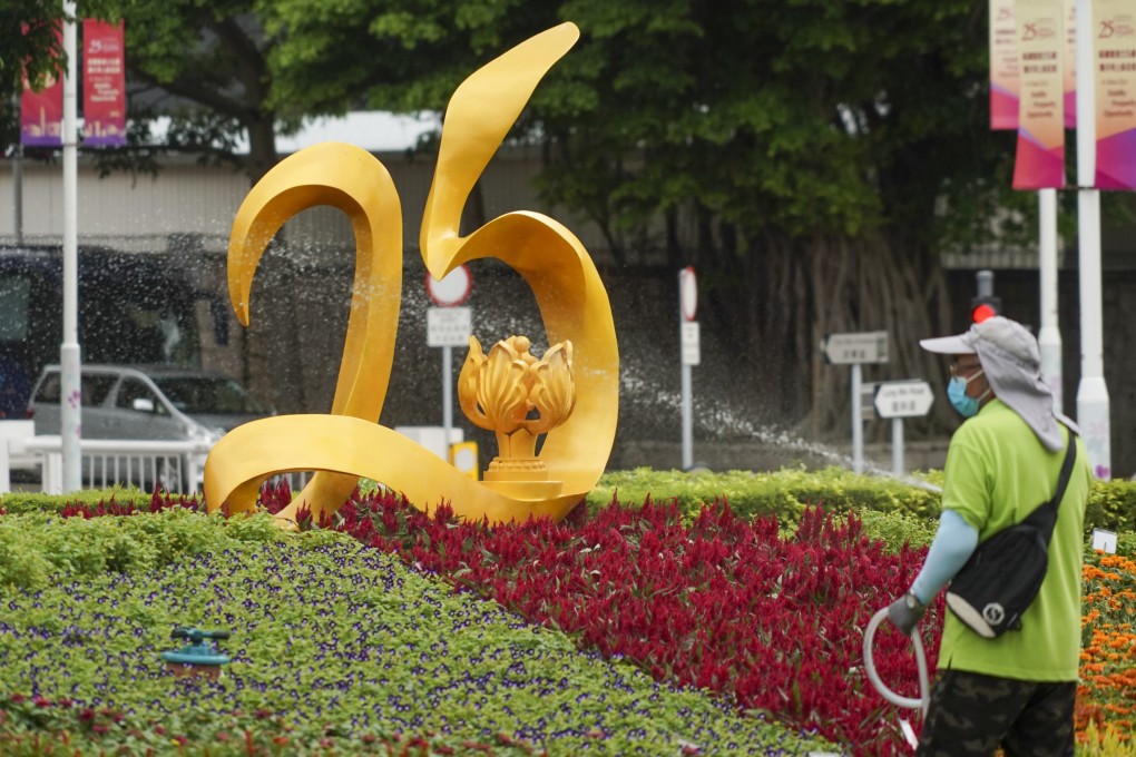 A worker waters plants at a new installation at Tamar Park, “Art@Harbour”, to celebrate the 25th anniversary of the establishment of the Hong Kong special administrative region. Photo: Felix Wong
