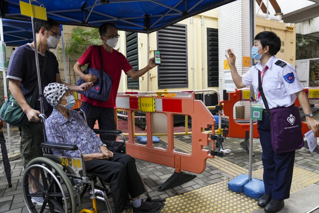 People use the Leave Home Safe app to enter Queen Elizabeth Hospital in Jordan on June 13. Photo: Sam Tsang