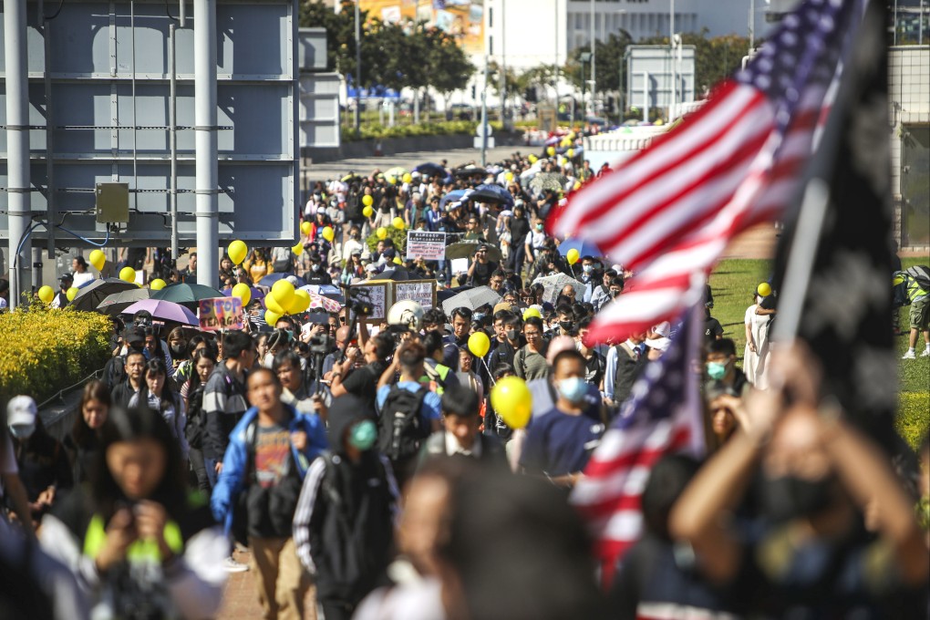 Hong Kong protesters in 2019 march to government offices, with some holding the US flag. Photo: Winson Wong