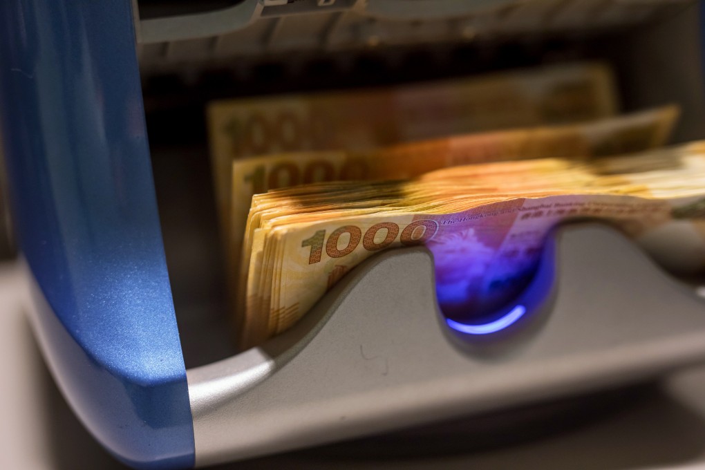 Hong Kong one-thousand dollar banknotes run through a counting machine at the Hang Seng Bank. Photo: Bloomberg