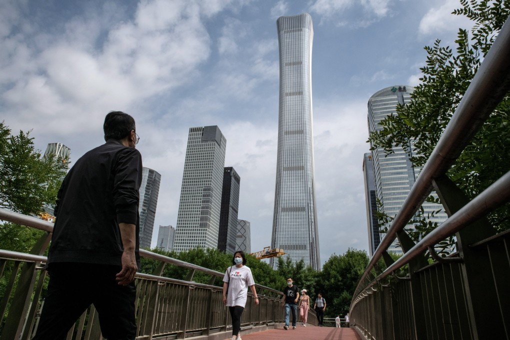 Pedestrians pass buildings in Beijing, China. Photo: Bloomberg