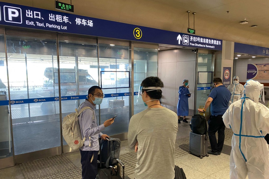 Inbound passengers at Beijing international airport wait to be taken to centralised quarantine centres. Photo: AFP