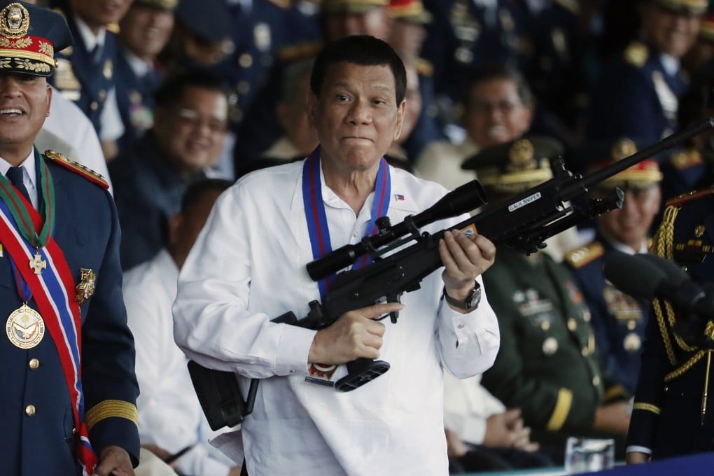 Rodrigo Duterte holds a sniper rifle during a ceremony at the national police headquarters on April 19, 2018. File photo: EPA-EFE