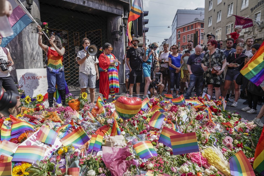 People stand at the scene of a shooting in front of an Oslo, Norway, nightclub, which happened hours before a Pride march. At least two people were killed and 21 injured. Photo: dpa
