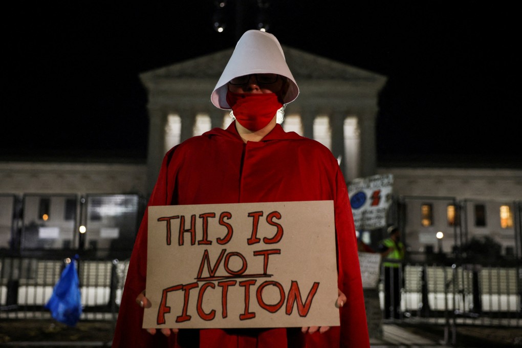 An abortion rights demonstrator dressed in a Handmaid’s Tale costume, protests outside the United States Supreme Court. Photo: Reuters