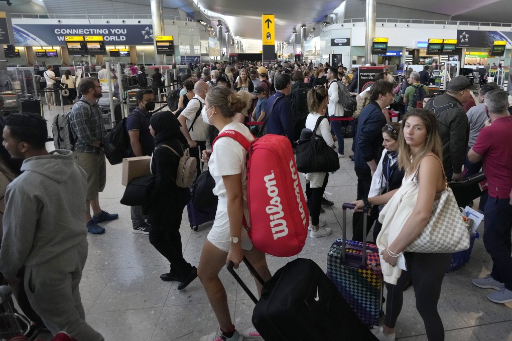 Travellers queue for security checks at Heathrow Airport in London on June 22. After two years of pandemic restrictions, travel demand is back with a vengeance but airlines and airports that slashed jobs during the depths of the Covid-19 crisis are struggling to keep up. Photo: AP