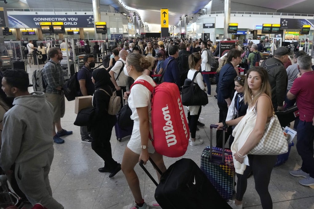 Travellers queue for security checks at Heathrow Airport in London on June 22. After two years of pandemic restrictions, travel demand is back with a vengeance but airlines and airports that slashed jobs during the depths of the Covid-19 crisis are struggling to keep up. Photo: AP