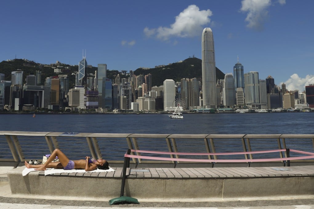 A woman enjoys sunbathing at the Avenue of Stars in Tsim Sha Tsui on June 23. Photo: Yik Yeung-man