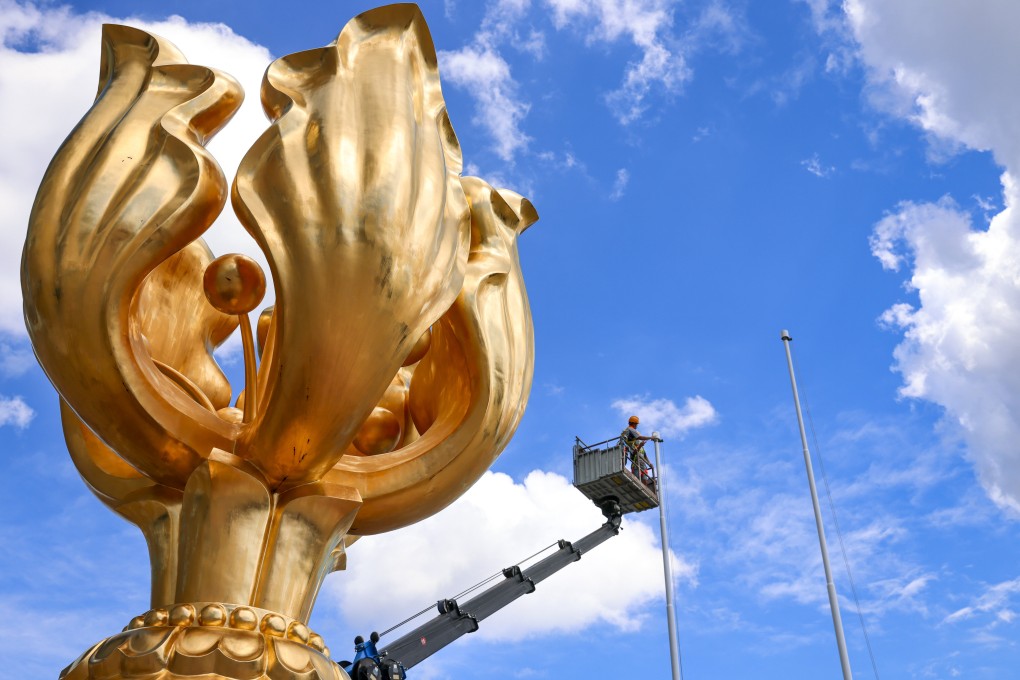 A worker repaints a flagpole at Golden Bauhinia Square in Wan Chai, the usual location for the July 1 flag-raising ceremony. Photo: Dickson Lee