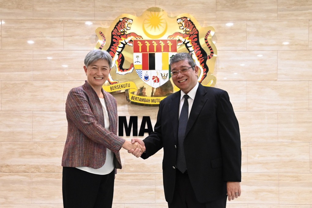Australian Foreign Minister Penny Wong greets her Malaysian counterpart Saifuddin Abdullah in Putrajaya on Tuesday. Photo: EPA-EFE/Ministry of Foreign Affairs