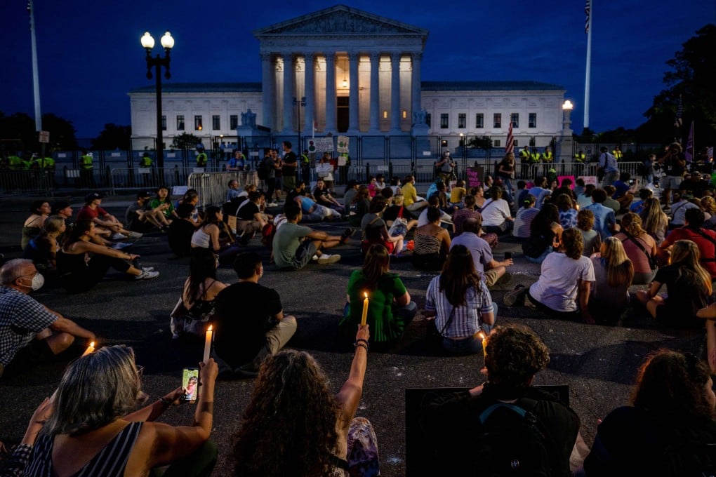 Protesters attend a candlelit vigil in front of the US Supreme Court in Washington on June 26 to denounce the court’s decision to end federal abortion rights protections. Photo: AFP