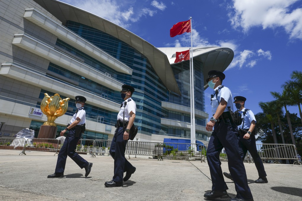 Police officers patrol outside the Hong Kong Convention and Exhibition Centre in Wan Chai ahead of July 1. Photo: Sam Tsang
