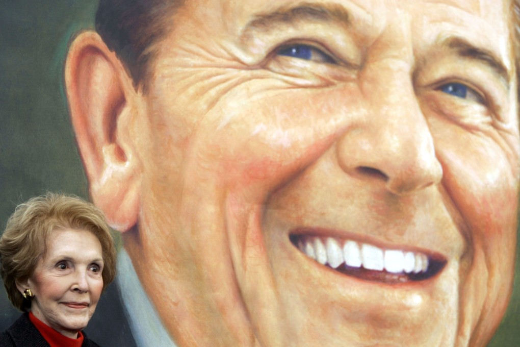 John Hinckley Jnr, he man who wounded President Ronald Reagan in 1981, apologised for his actions. Pictured is Reagan’s widow, Nancy Reagan, in front of a promotional image for the Ronald Reagan commemorative postage stamp in 2004. Photo: Reuters