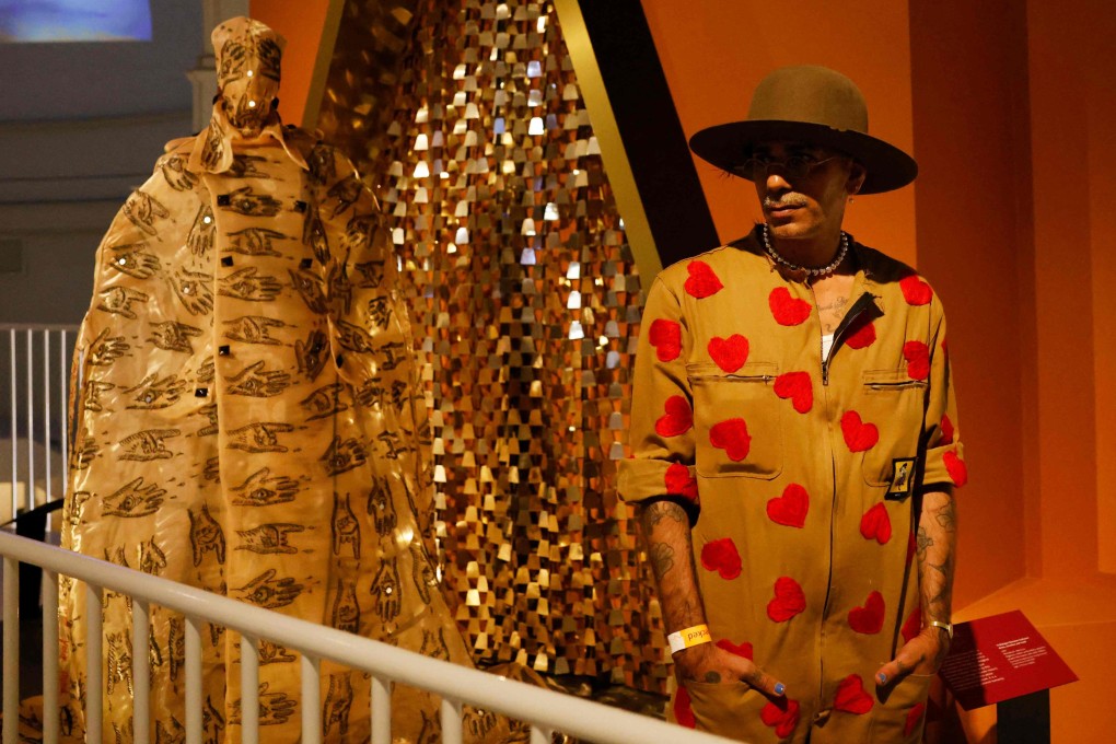 Moroccan fashion designer Artsi Ifrach poses for a photograph next to his creation “A Dialogue Between Cultures” at the Victoria and Albert museum in London on June, 27, 2022. Photo: AFP