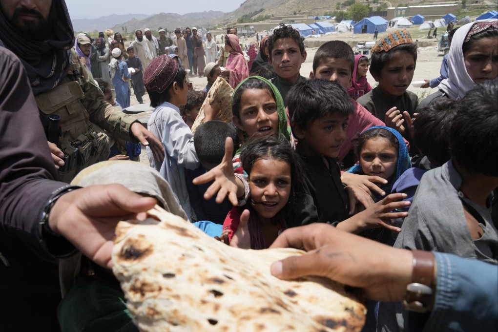 Afghans receive aid at a camp after the earthquake in Paktika province. Photo: AP