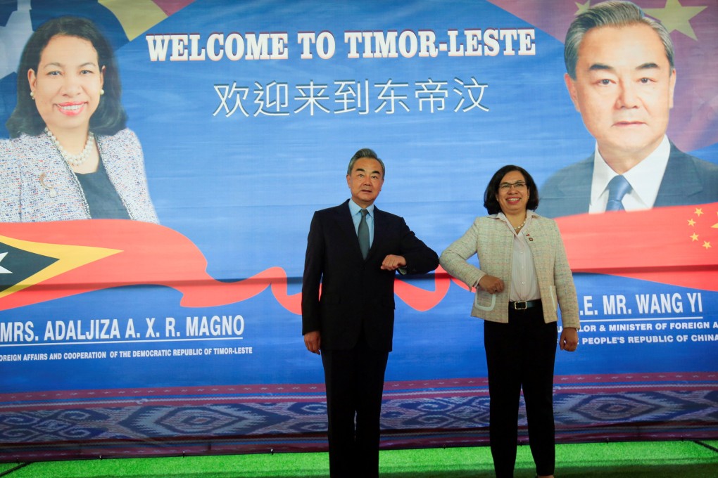 Chinese Foreign Minister Wang Yi bumps elbows with East Timor’s Minister of Foreign Affairs and Cooperation Adaljiza Magno in East Timor on June 3. Photo: Reuters
