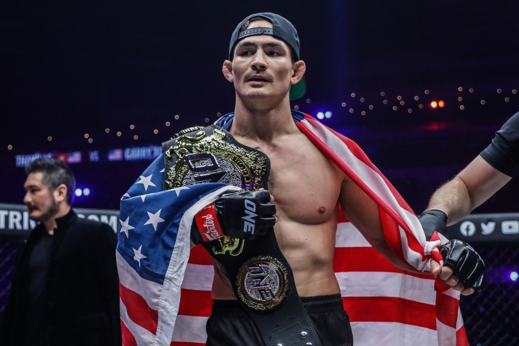 Thanh Le celebrates with his featherweight title after knocking out Garry Tonon at ONE: Lights Out. Photos: ONE Championship