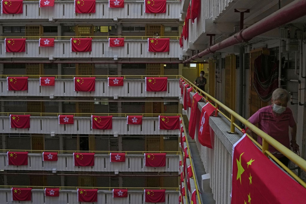 Chinese and Hong Kong flags hang over the walkways at a public housing estate in the city on June 25. Photo: AP