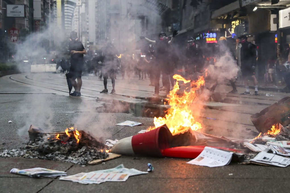 Anti-government protesters set fire to objects in Wan Chai following a rally in defiance of the anti-mask law issued by the government on October 5, 2019. Photo: Sam Tsang