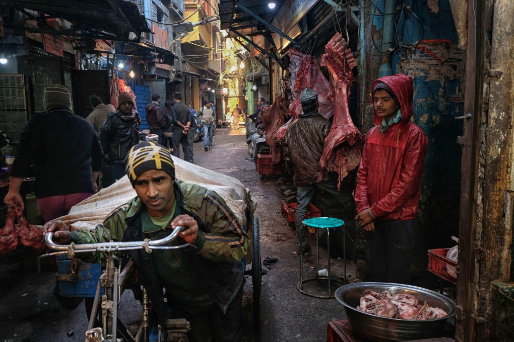 An Indian labourer pulls buffalo meat on his cycle-rickshaw as butchers wait for customers at a meat market in the old quarters of New Delhi on January 16, 2019. Photo: AFP