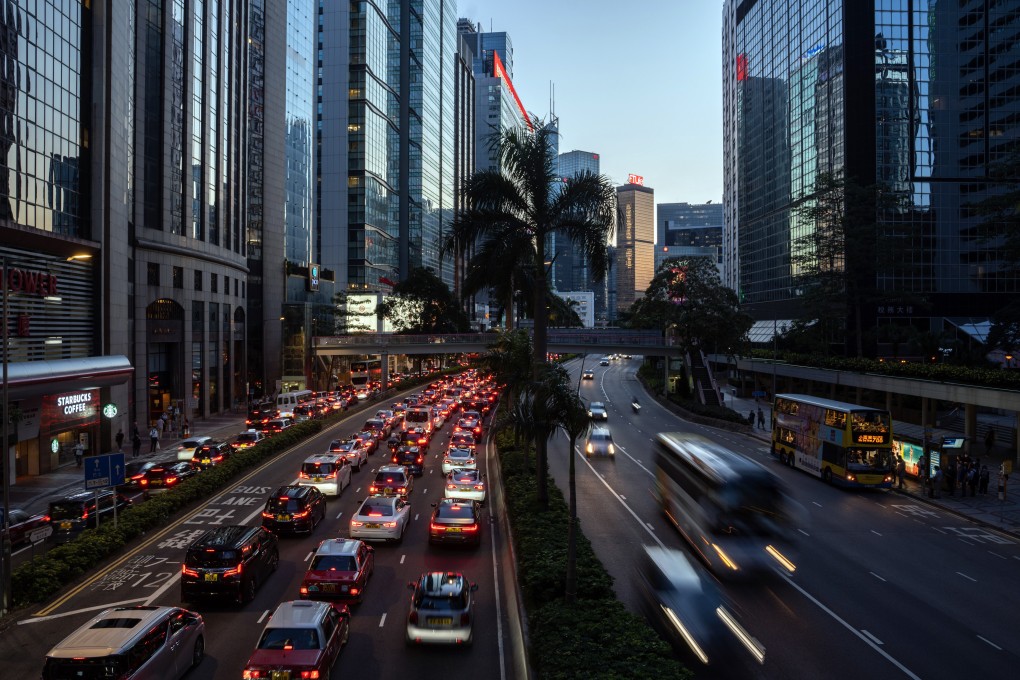 Vehicles travel along a road in Hong Kong on June 28. Businesses are relocating all or part of their operations to places where talent is both available and happy to work. Bloomberg