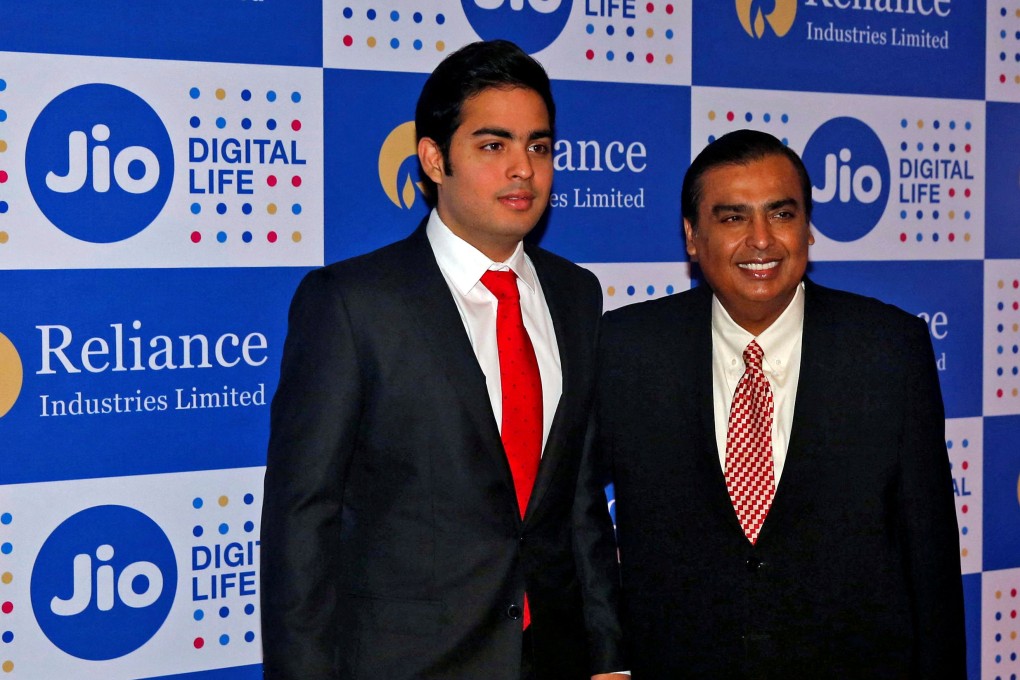 Mukesh Ambani (R) and his son Akash, two of the world’s richest men. Mukesh has stepped aside in some of the family conglomerate to make way for 30-year-old Akash. File photo: Reuters