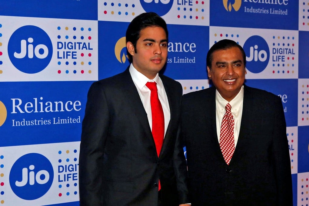 Mukesh Ambani (R) and his son Akash, two of the world’s richest men. Mukesh has stepped aside in some of the family conglomerate to make way for 30-year-old Akash. File photo: Reuters