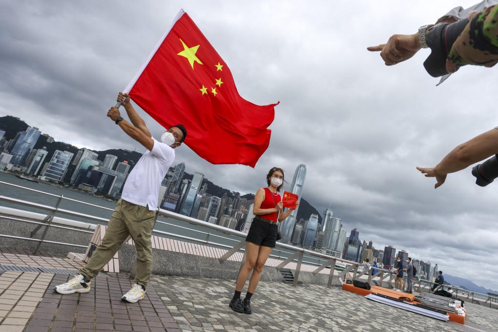 Residents celebrate the 25th anniversary of the city’s handover on the Tsim Sha Tsui promenade on Friday. Photo: Nora Tam