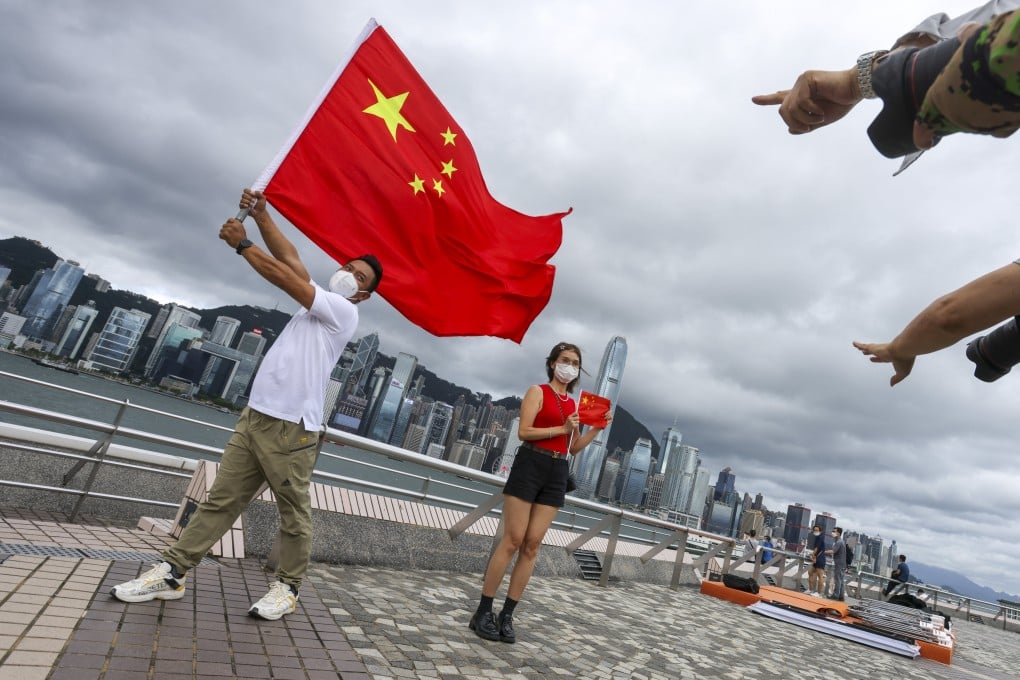Residents celebrate the 25th anniversary of the city’s handover on the Tsim Sha Tsui promenade on Friday. Photo: Nora Tam