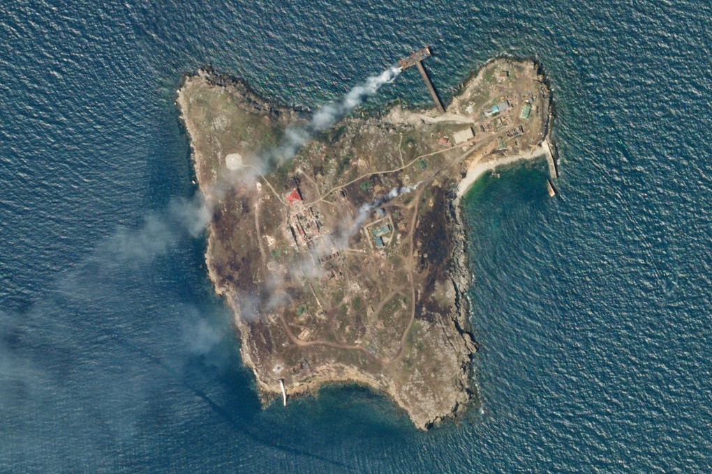 A satellite image shows smoke rising from Snake Island off the coast of Ukraine on Wednesday. Image: Planet Labs PBC via Reuters