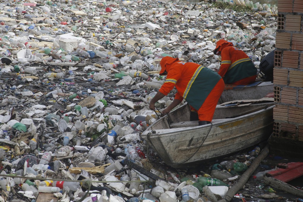 City workers remove plastics and other garbage floating on a river in Manaus, Brazil’s Amazonas state, last month. Photo: AP