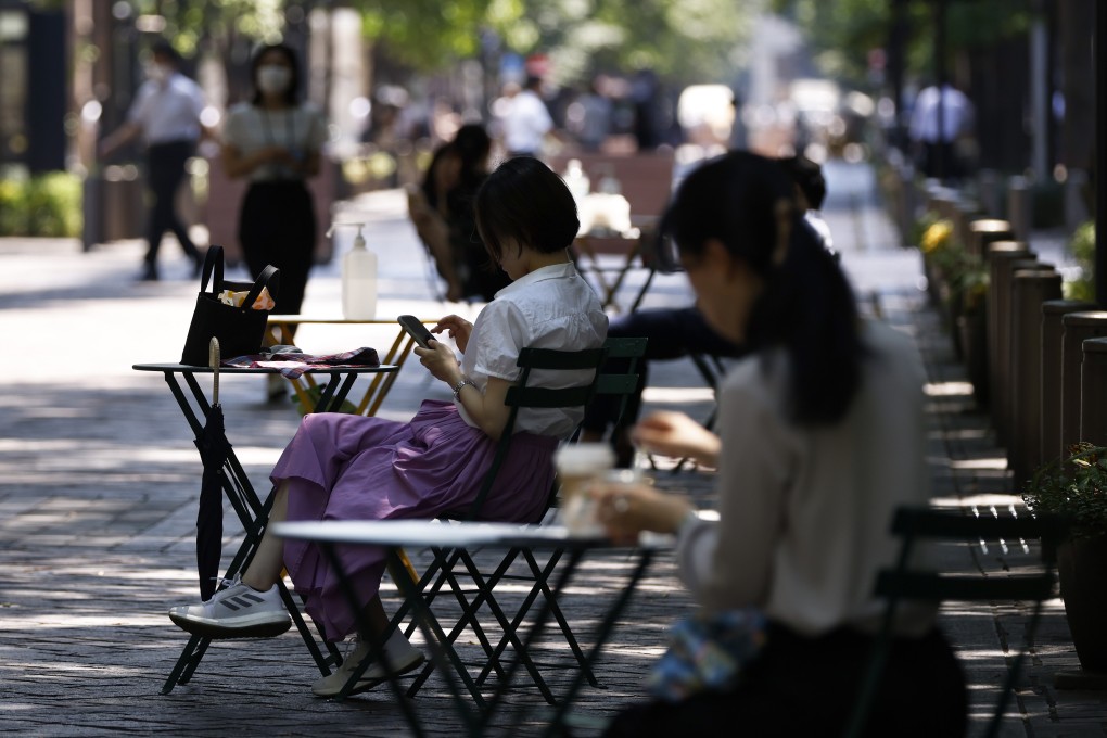 Women sit in the shade in Tokyo on Friday. A 2019 survey found that some one-in-five Japanese women in their 20s were underweight. Photo: Bloomberg