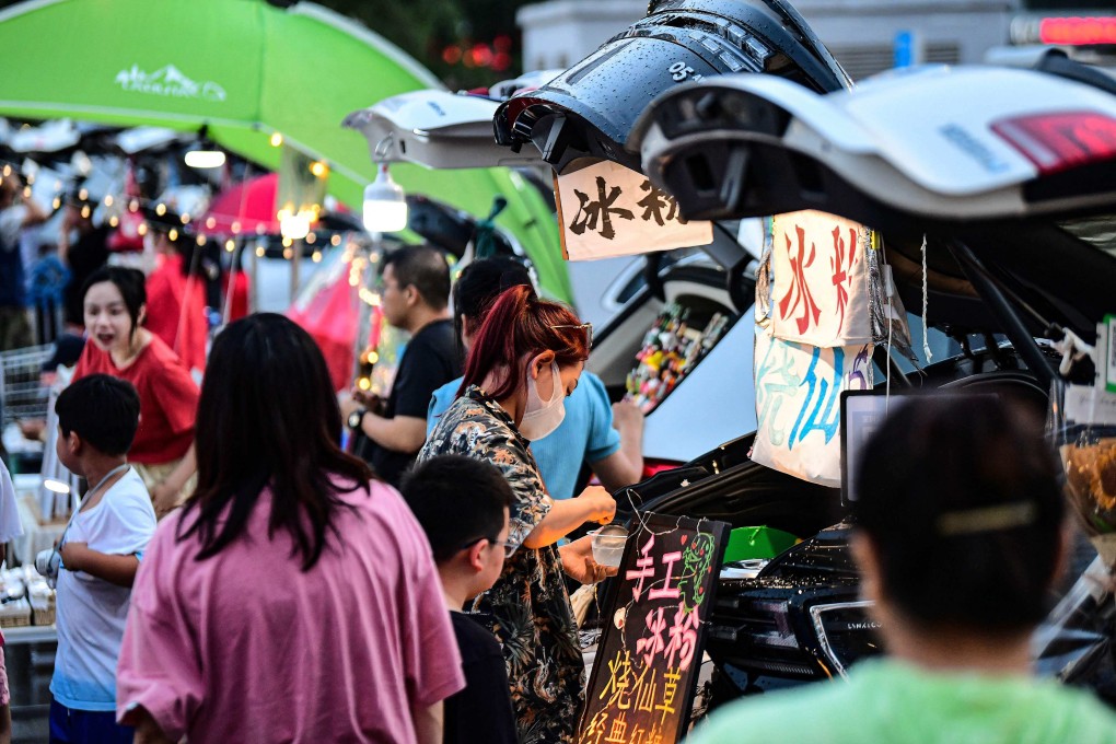 People run stalls from car boots at a market in  a car park in the northeastern Chinese city of Shenyang on July 2. Recent data suggests China’s economy is starting to pick up. Photo: AFP