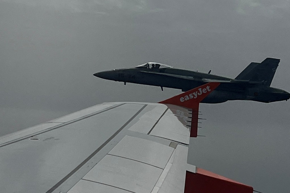 A Spanish F-18 jet fighter, escorts an Easyjet flight heading from London to the Spanish holiday island of Menorca, after a hoax bomb threat by an 18-year-old British passenger. Photo: Marcus Torr/via Reuters