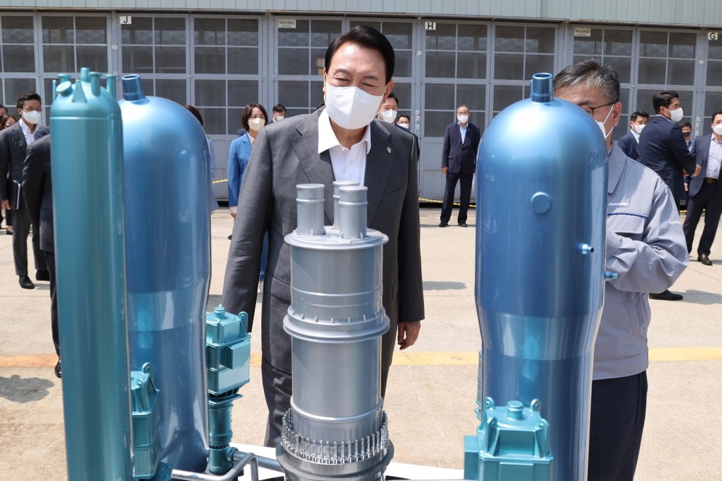 South Korean President Yoon Suk-yeol admires a model of a domestically developed nuclear reactor as he tours a factory in Changwon last month. Photo: EPA-EFE