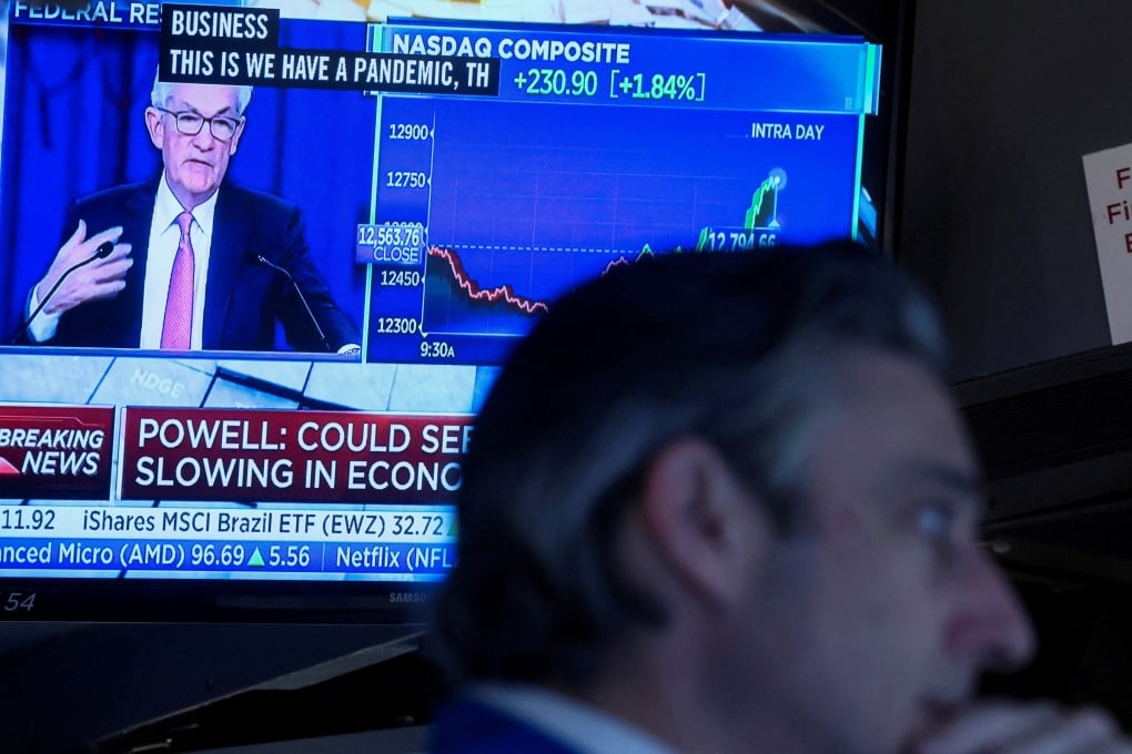 A trader works on the floor of the New York Stock Exchange on May 4 as US Federal Reserve chairman Jerome Powell delivers remarks on a screen. Photo: Reuters