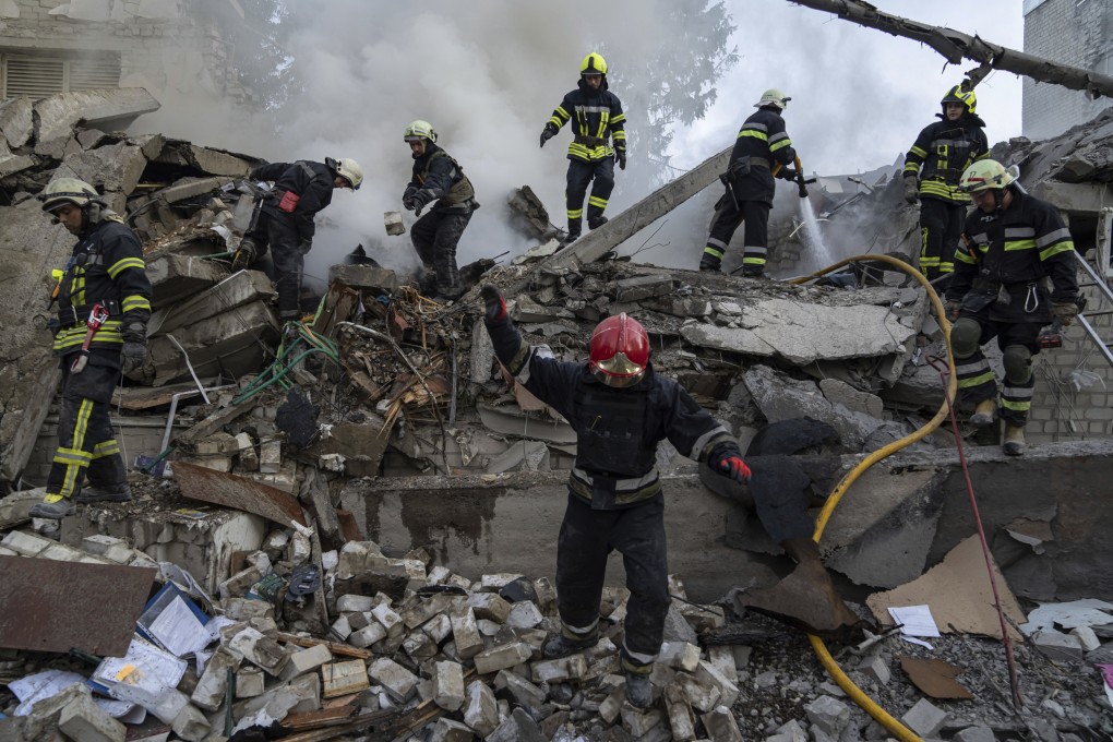 Rescue workers clear rubble at a destroyed school after an attack in Kharkiv, Ukraine on Monday. Photo: AP